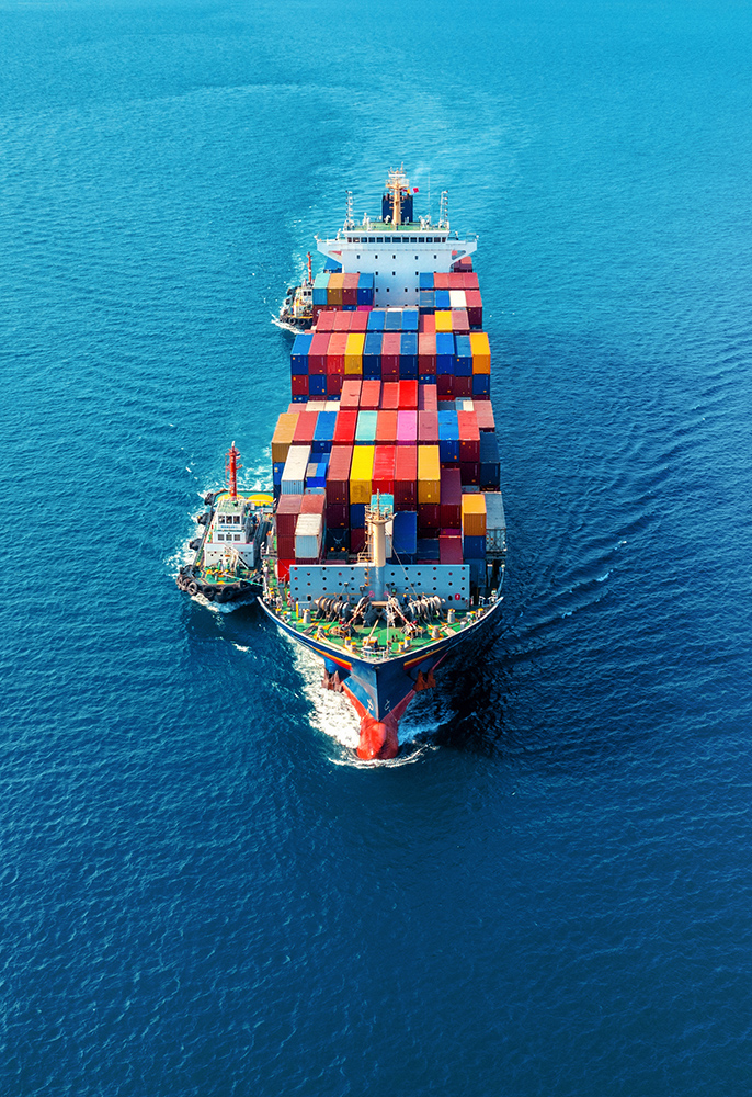 Aerial view of cargo ship with cargo container on sea.